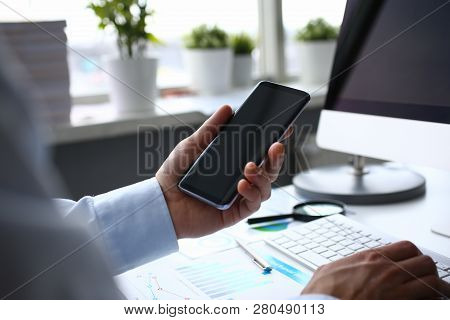 Businessman Hipster Holds Telephone Background Of Computer Keyboard In Office Clodeup. Make Transact
