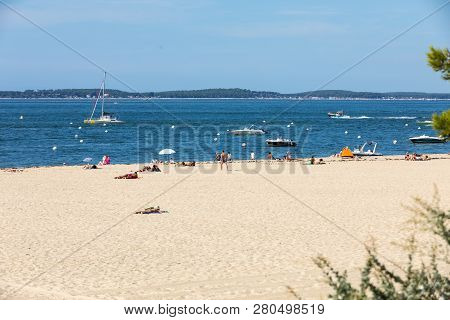 Arcachon, France - September 10, 2018: People Are Enjoying A Sunny Day On A Sandy Beach In Arcachon,