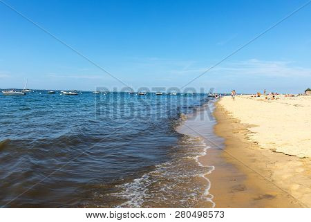Arcachon, France - September 10, 2018: People Are Enjoying A Sunny Day On A Sandy Beach In Arcachon,