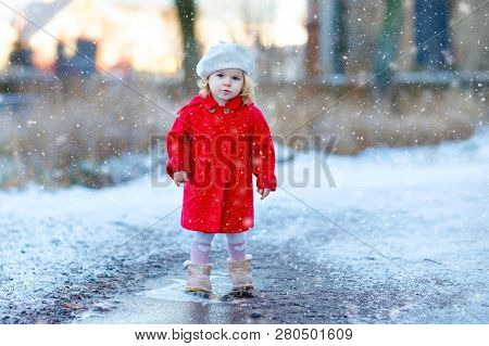 Outdoor Winter Portrait Of Little Cute Toddler Girl In Red Coat And White Fashion Hat Barret. Health