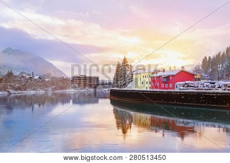 Beautiful Scenic Sunset Over River Inn In Kufstein Town With Trees Covered With Snow And Mountains O