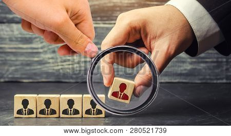 Wooden Blocks With A Picture Of Workers. The Businessman Or Ceo Removes / Dismisses The Employee. Ma