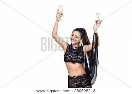 Beautiful Young Girl Happily Celebrates Her Victory. Woman With A Glass Of Champagne And A Winner St