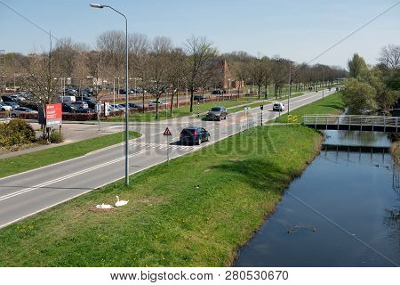Lelystad, The Netherlands - April 18, 2018: Major Road In Early Springtime Along Car Park And Ditch 