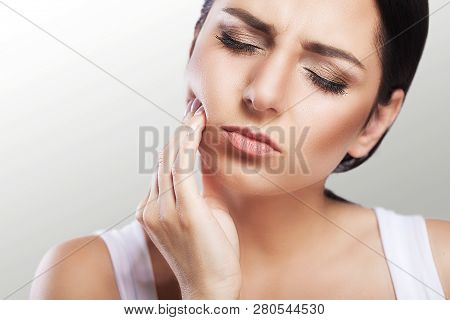Pain. Teeth Problem. Woman Feeling Tooth Pain. Closeup Of A Beautiful Sad Girl Suffering From Strong