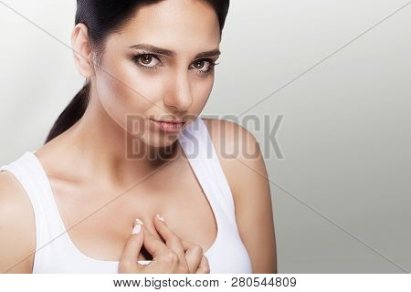 Pain. The Woman Is In Pain. A Beautiful Young Woman Feels An Acute Severe Chest Pain. The Girl Suffe
