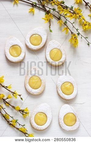 Homemade Easter Lemon Cookies And Forsythia Blooming Twigs On A Light Background.