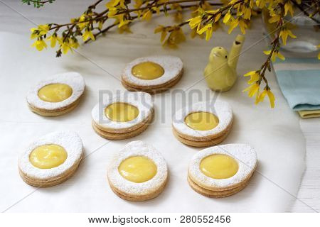 Homemade Easter Lemon Cookies And Forsythia Blooming Twigs On A Light Background.