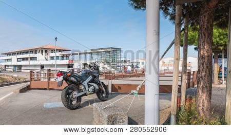Yeu Island, France - September 18, 2018: Motorcycle Parked In Harbor Port Joinville Near Boats On A 