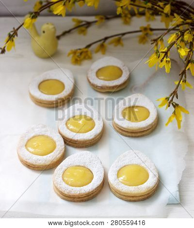 Homemade Easter Lemon Cookies And Forsythia Blooming Twigs On A Light Background.