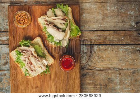 sandwich with chicken and lettuce. food background. copy space