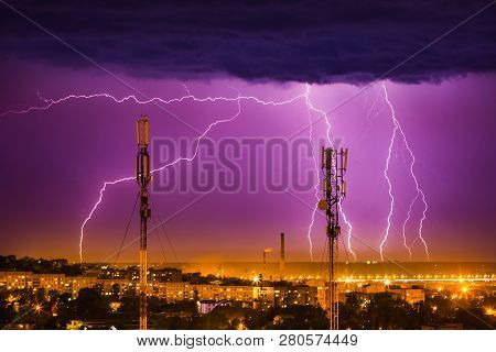 Storm Lightning On The Horizon Over Telephone Towers