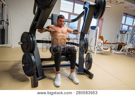 Athlete Does Deltoid Exercises On Hammer Machine