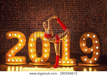 Beautiful Woman Doing Yoga On Christmas Background