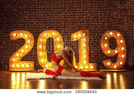 Beautiful Woman Doing Yoga On Christmas Background