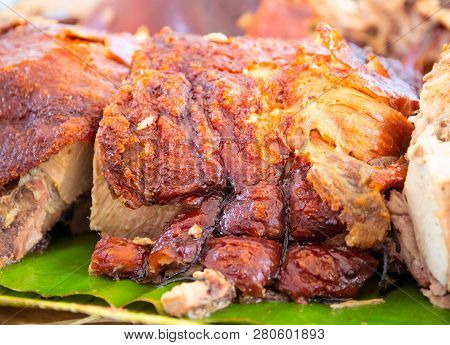 Roasted Pork Meat Cooked On Grill. Traditional Cuisine. Sliced Pork Barbecue With Gold Skin. Spanish