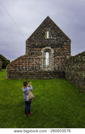 Woman Photographs The Ruins Of The Nunnery On The Island Of Iona