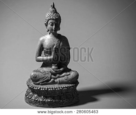 Zen Buddah Statue Casting A Shadow In Light