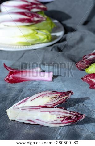 Group Of Fresh Green Belgian Endive Or Chicory And Red Radicchio Vegetables, Also Known As Witlof Sa