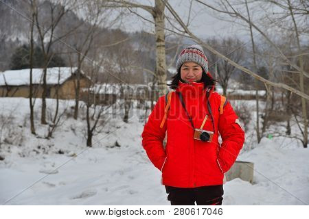 Woman Walking At Snow Village In China