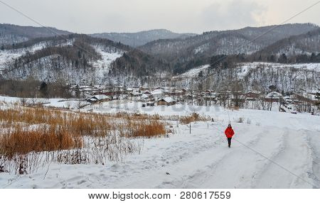 Woman Walking At Snow Village In China