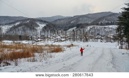 Woman Walking At Snow Village In China