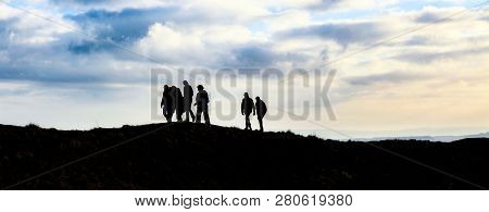 Group Of Hikers On The Ridgeway Trail Across Barbury Castle, Swindon, Wiltshire, Uk