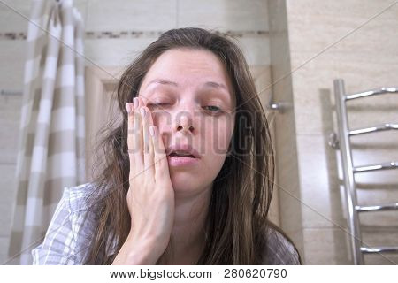 Woken Tired Woman In The Bathroom With Hangover And Headache.