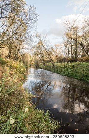 Stonavka River With Trees And Clouds Mirroring Near Its Junction With Olse River In Karvina City In 