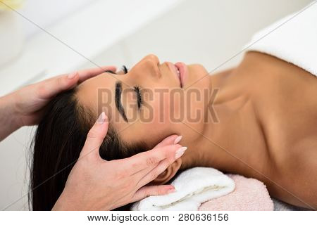 Woman Receiving Head Massage In Spa Wellness Center.