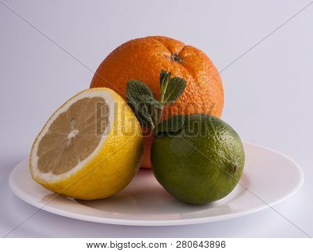 Lemon, Lime And Orange - Citrus Fruits On White Dish