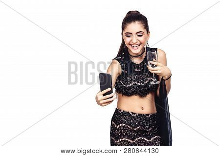 Young Gorgeous Girl Holds A Glass Of Champagne And Taking Selfie. Isolated On White