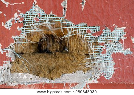 Old Wall With Peeling Plaster. Inside The Building A Hole With Insulation. Background. Testure