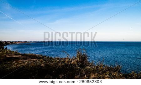 Baltic Sea From Cliff In Mechelinki, Poland. Nature And Travel Concept. Copy Space On Blue Sky.