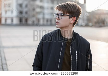 Handsome Hipster Young Man In Stylish Glasses With A Fashionable Hairstyle In A Stylish Outerwear On