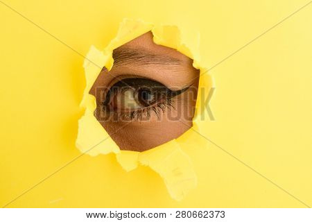 Eye Close Up. Spying, Secret. Beautiful Female Eye With Simple Make Up Is Looking At Camera Through 