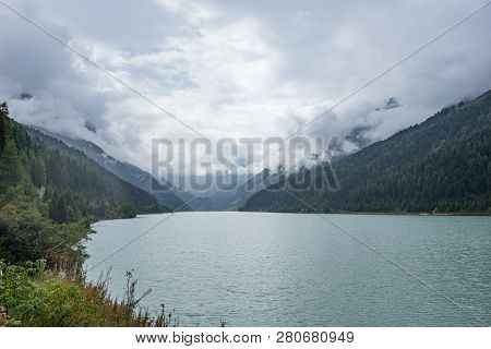 Mountains, Peaks, Lake, Everlasting Ice And Trees Landscape. Kaunertaler Gletscher Natural Environme