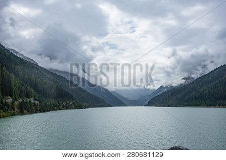 Mountains, Peaks, Lake, Everlasting Ice And Trees Landscape. Kaunertaler Gletscher Natural Environme
