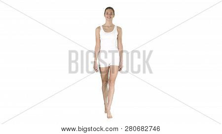 Lady Walking In White Sports Lingerie And Smiling On White Background.