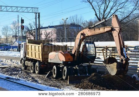 The Excavator Loads Crushed Stone In A Dump Truck Body. Construction Of The Railway. Preparing The S