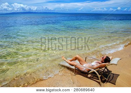 Young Woman In Bikini Lying In A Sun Chair On Taveuni Island, Fiji. Taveuni Is The Third Largest Isl