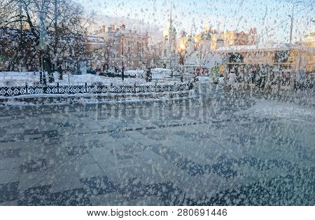 Frost Patterns On A Glass. City View Through A Frosted Window. Concept Of Extremely Cold Weather Con