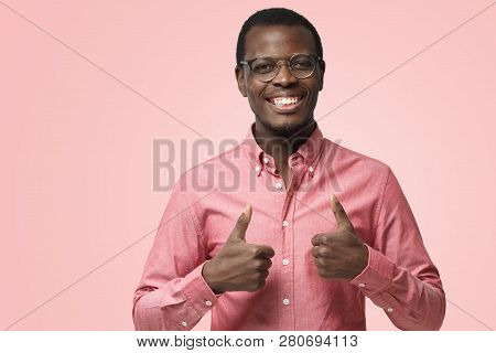 Young Excited Happy Afrcian American Business Man Showing Thumbs Up, Isolated On Pink Background. Co