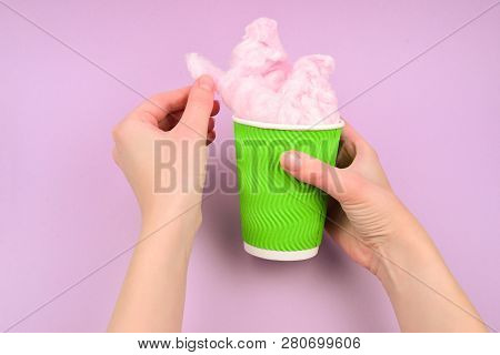 Bright Pink Candy Cotton In Plastick Cup In Woman Hand On Lilac Background.