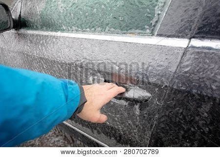 Transportation, Winter, Weather, Vehicle Concept. Hand On Car's Door Handle Covered In Snow And Icy 