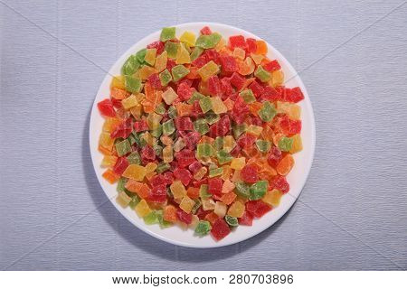 Pineapple Slices On The Plate. Four Colours Mixed. Candied Fruit.