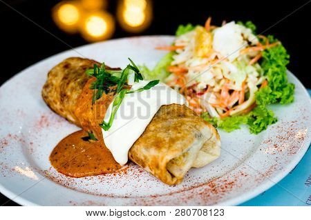 Oven Baked Chicken Chimichanga, With Red Beans, Rice, Cheese And Tomato Topped With Sour Cream