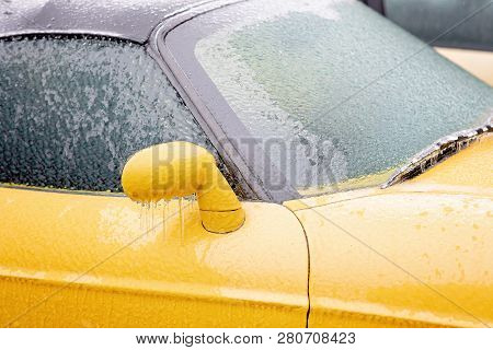 Transportation, Winter, Weather, Vehicle Concept. Car Covered In Snow And Icy Rain In Winter. Blizza
