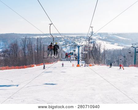 Skiers And Snouborders On A Ski Lift Pov In Winter Time. The Cable Car Lifts The Peoples Up To The S