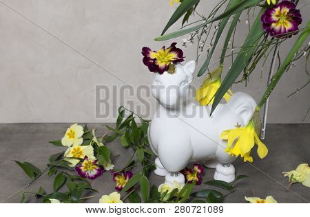 A White Unicorns With Lots Of Colorful Spring Flowers